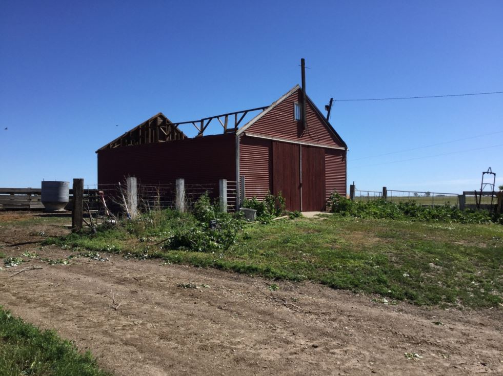 Farm building lost roof, with debris thrown to the north and northeast. (NWS Storm Survey)