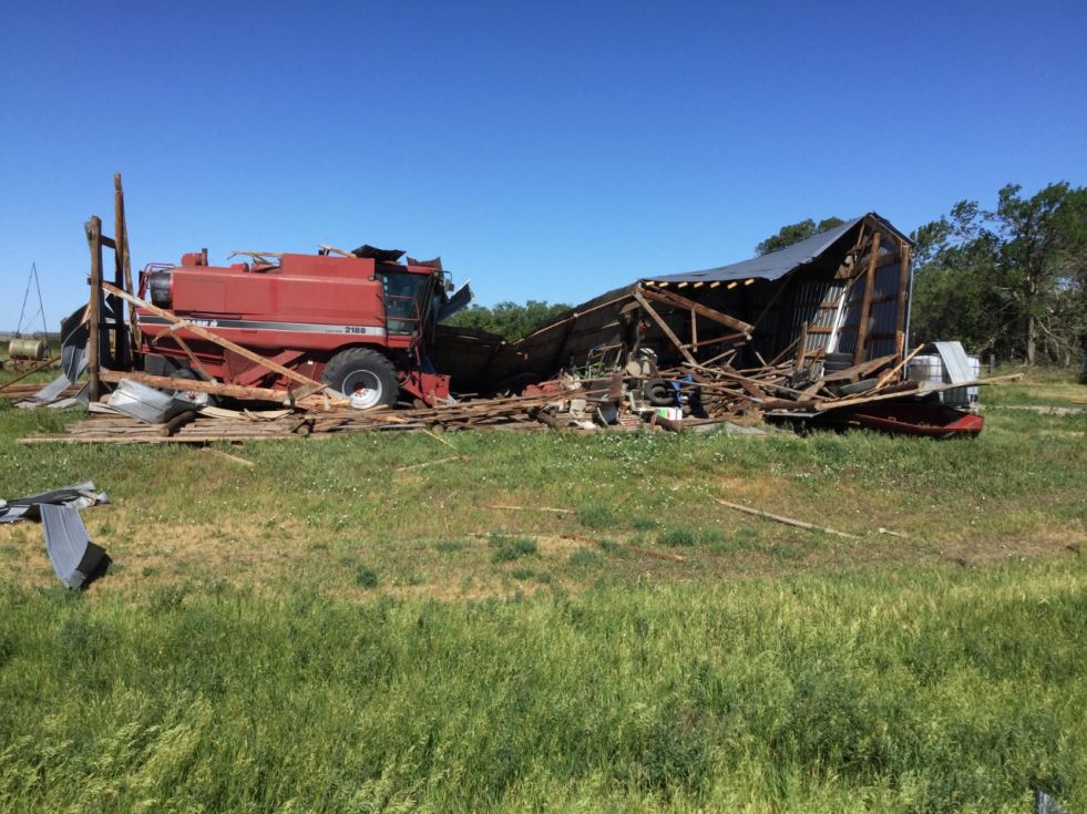 Farm Shed damaged, with debris spread into farm field to the east. 