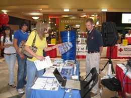 Meteorological Intern Robert Hart discussing the 2009 edition of Skywatcher chart with a visitor, La Plaza Mall Hurricane Expo, McAllen
