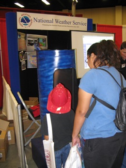 A mother and son check out the NWS Brownsville tornado chamber at the Hidalgo County Disaster Readiness Expo, McAllen