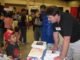 Forecaster Ryan Vipond answers questions from youngster at Hidalgo County Readiness Expo, McAllen