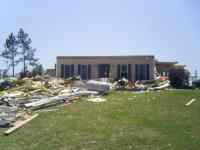 [ Top floor removed from two-story home by EF3 tornado in rural Montgomery County. ]