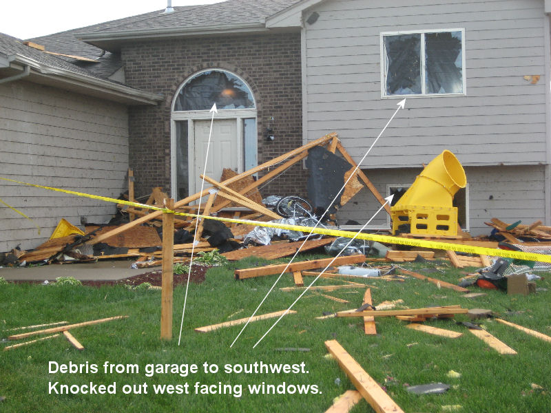 Debris from garages deposited in front yard of neighboring house.