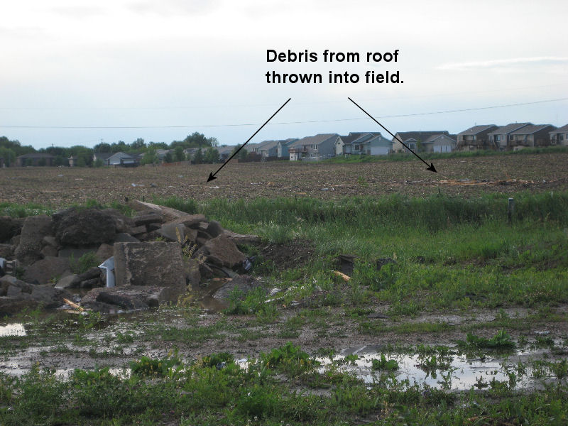 Debris from roof in the field.