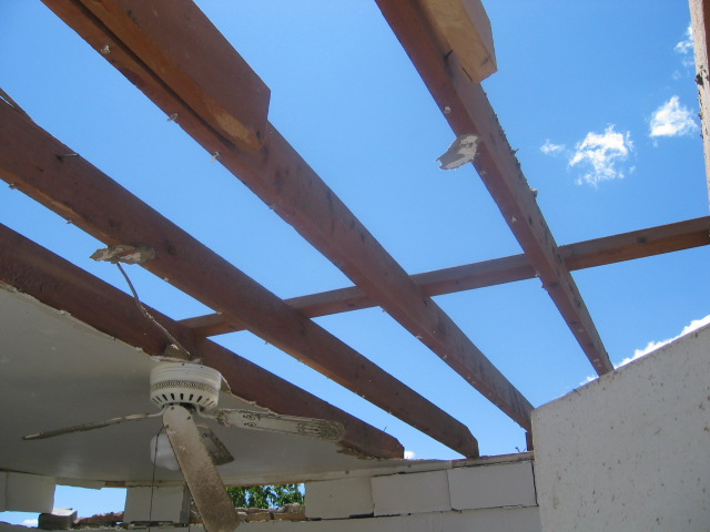 storm damage showing roof removed from a house