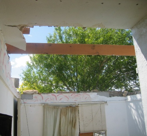 storm damage showing roof removed from a house