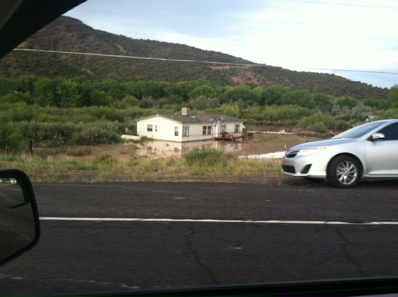 The Rio Chama flooded out of its banks, causing damage to nearby homes. Water reached just beneath the windows of this home near Chamita. Image taken on September 18, 2013.