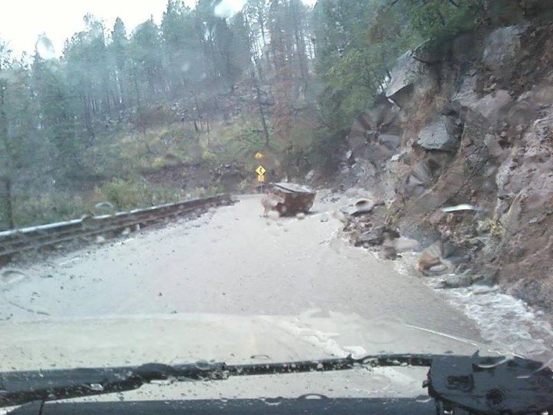 Heavy rain and flooding created landslides in portions of Los Alamos and Sandoval counties. A large boulder is seen here that slid down the hillside adjacent to NM Highway 4. Image by Phil Taylor.