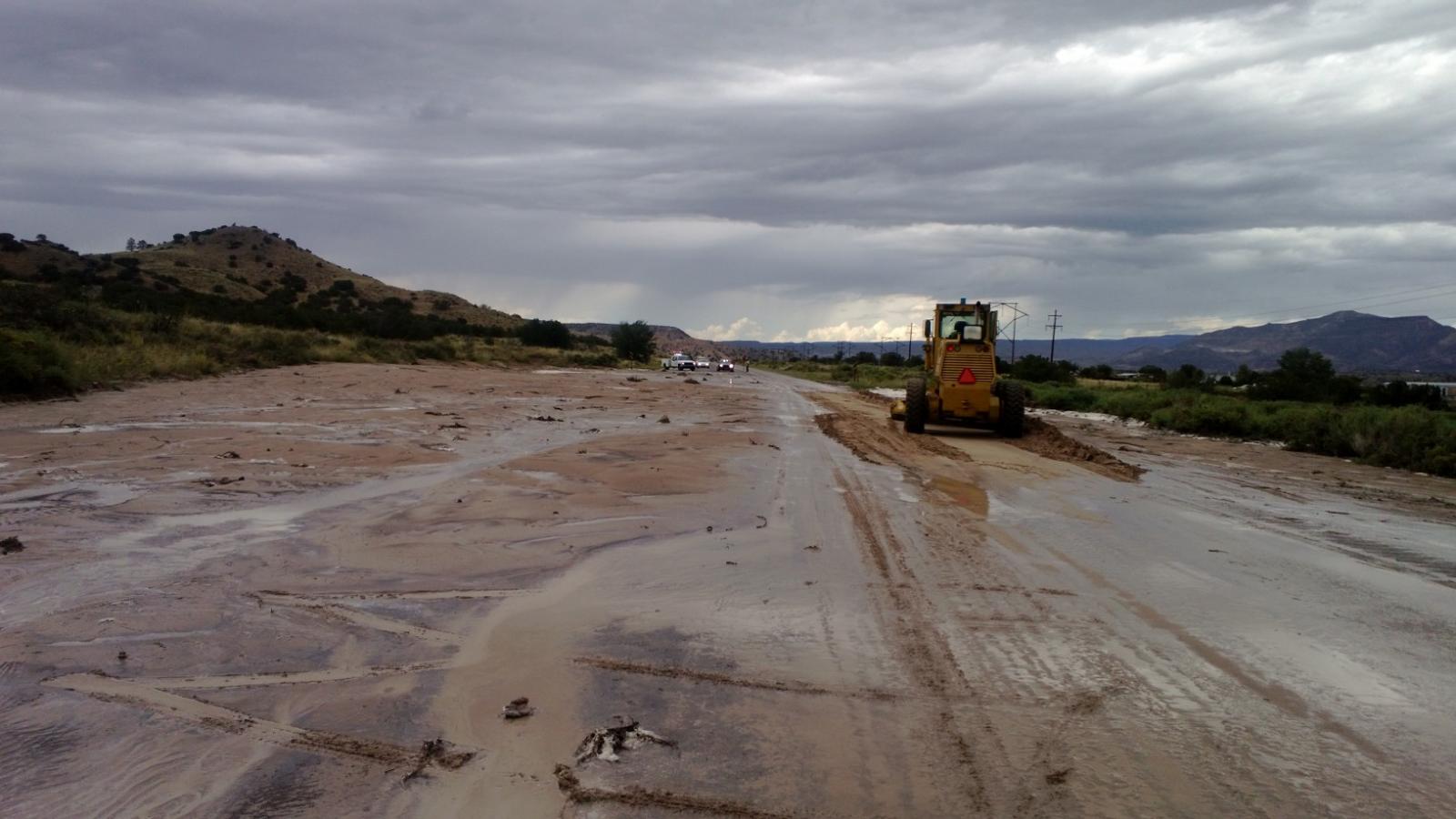 Road graders had to be used to clear mud and debris from U.S. Highway 84 near Chili on September 18, 2013.