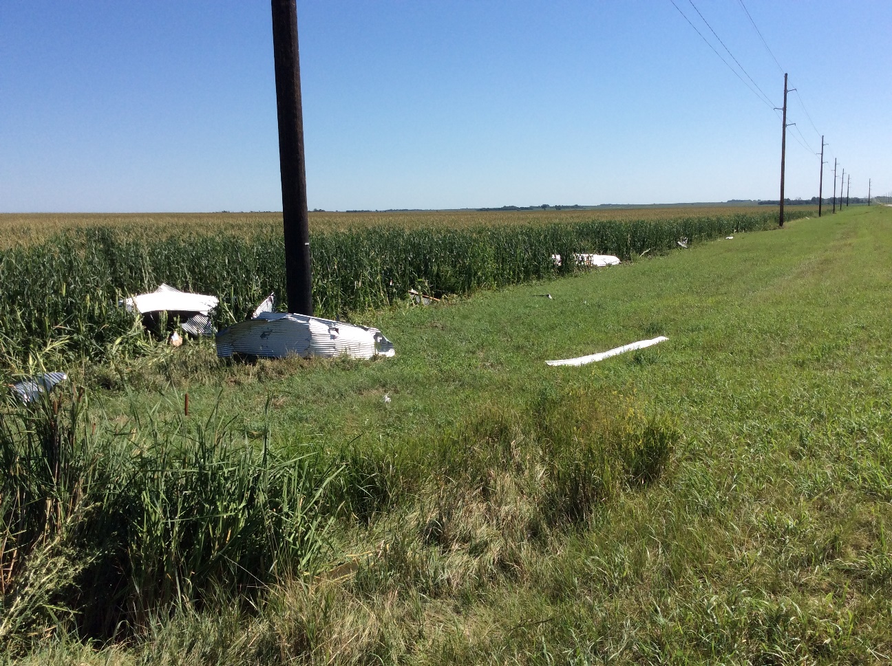 Metal from the outbuilding 1 mile east of Andover was thrown northeast across Highway 12