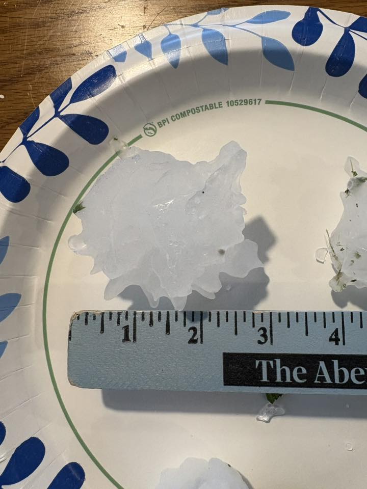 Hail stone on a plate being measured at 3 inches