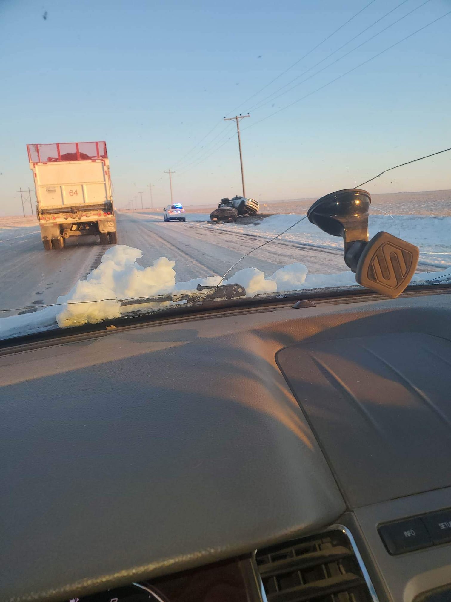 Photo by Destinie Jones of a snow-covered road and a truck that lost control near Hartley, Texas on February 15th, 2023