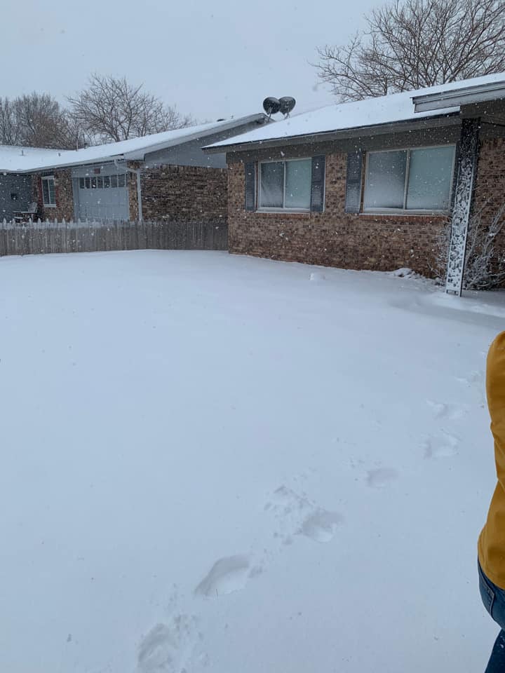 Photo by Esmeralda Munoz of a few inches of snow on a front yard in Dumas, Texas on February 15th, 2023