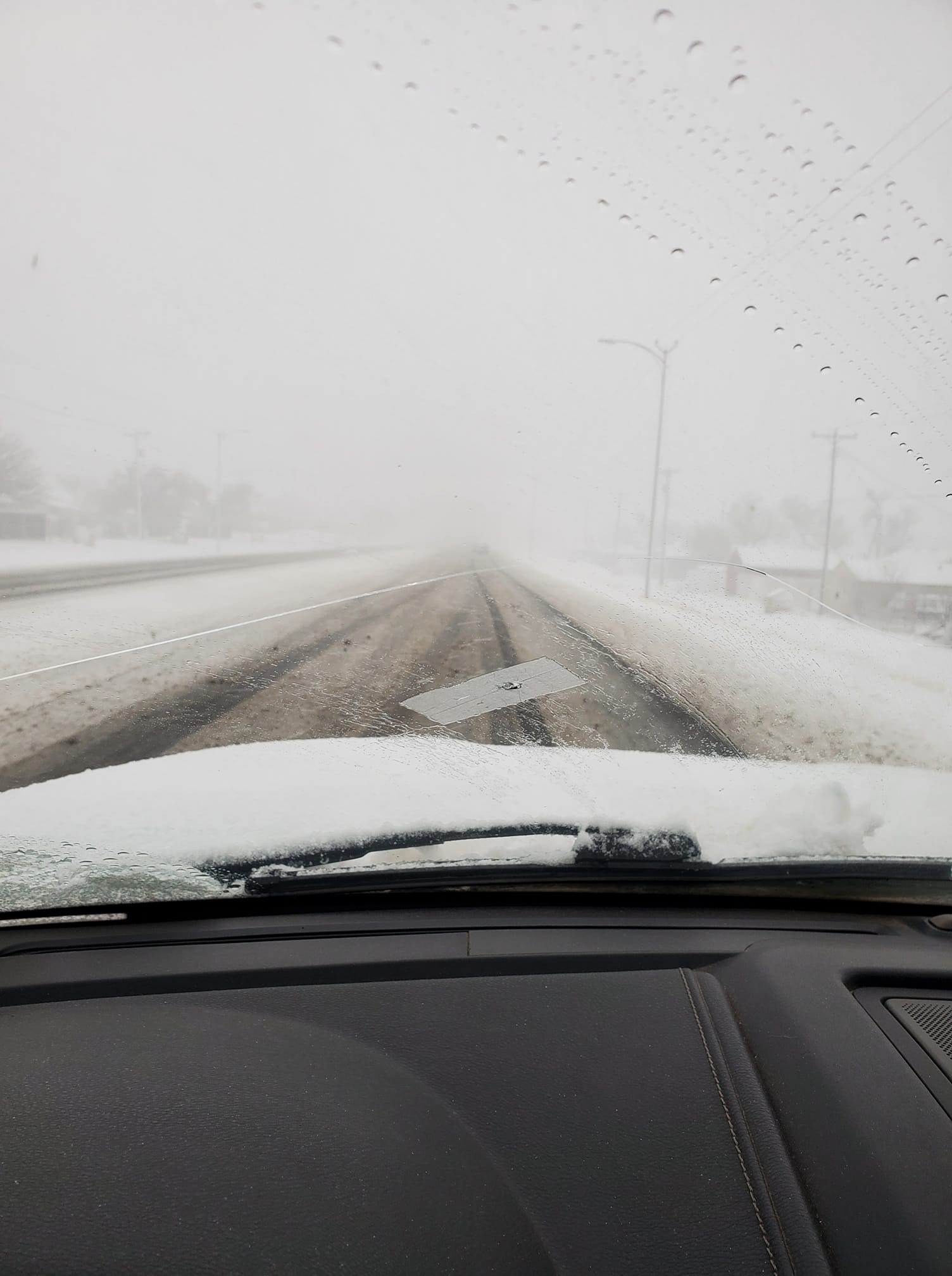 Photo by Kyle Lesley of a snowy road in Borger, Texas on February 15th, 2023