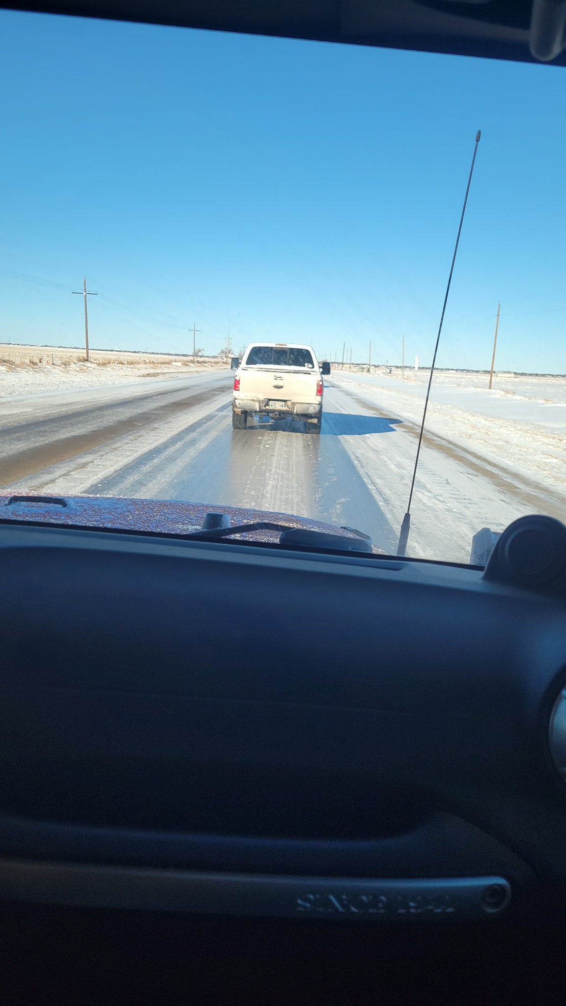 Photo by Meaghan Shipley of an ice covered road between Stinnett and Dumas, Texas the morning after the February 15th, 2023 snow event