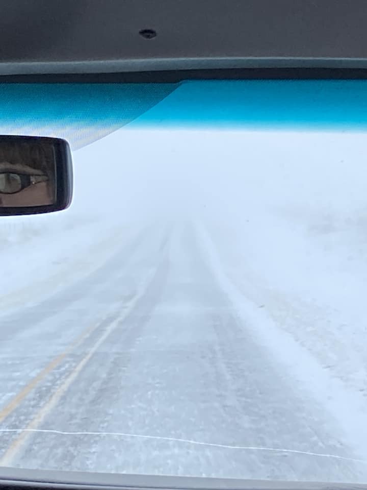 Photo by Tuan Clay of a light layer of snow covering the road outside of Channing, Texas on February 15th, 2023