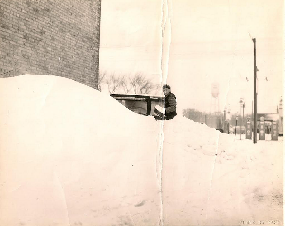 Charles F. Dare, age 18, shoveling out the Sherburne County Star News delivery truck in Elk River, MN after the Armistice Day blizzard.