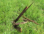 Piece of wood thrown by tornado like missile into ground.