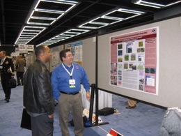 Mike Castillo, Forecaster at NWS Brownsville/Rio Grande Valley, answering questions from visitor to poster session on Rio Grande Flood of 2010 (click to enlarge)