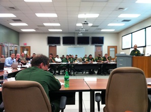 Photo of the exercise player table and US Customs and Border Protection observers, with Juan Garces, Co-Event Coordinator