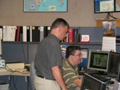 Science and Operations Officer Jeral Estupinan and Mike Castillo discuss Dolly (click to enlarge)