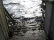 Wooden stairs with handle broken by crashing waves (click to enlarge)