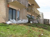 Sandbagged cabana suites with debris indicating possible earlier flooding (click to enlarge)