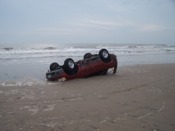Vehicle buried in sand on September 13, from waves on September 12 (click to enlarge)