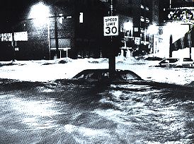A car stranded in flood waters - water up to the windows