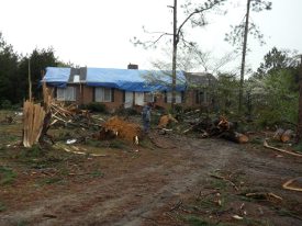 Photo of tornado damage to a house.