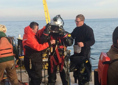 (U.S. Coast Guard) A diver, wearing a positive pressure dive suit, is inspected by his coworkers prior to conducting dive operations for the Argo response in Lake Erie. Divers conducting operations during the Argo response are required to wear specialized dive suits designed for the utmost safety to the diver while ensuring flexibility, ease of decontamination, and chemical resistance.