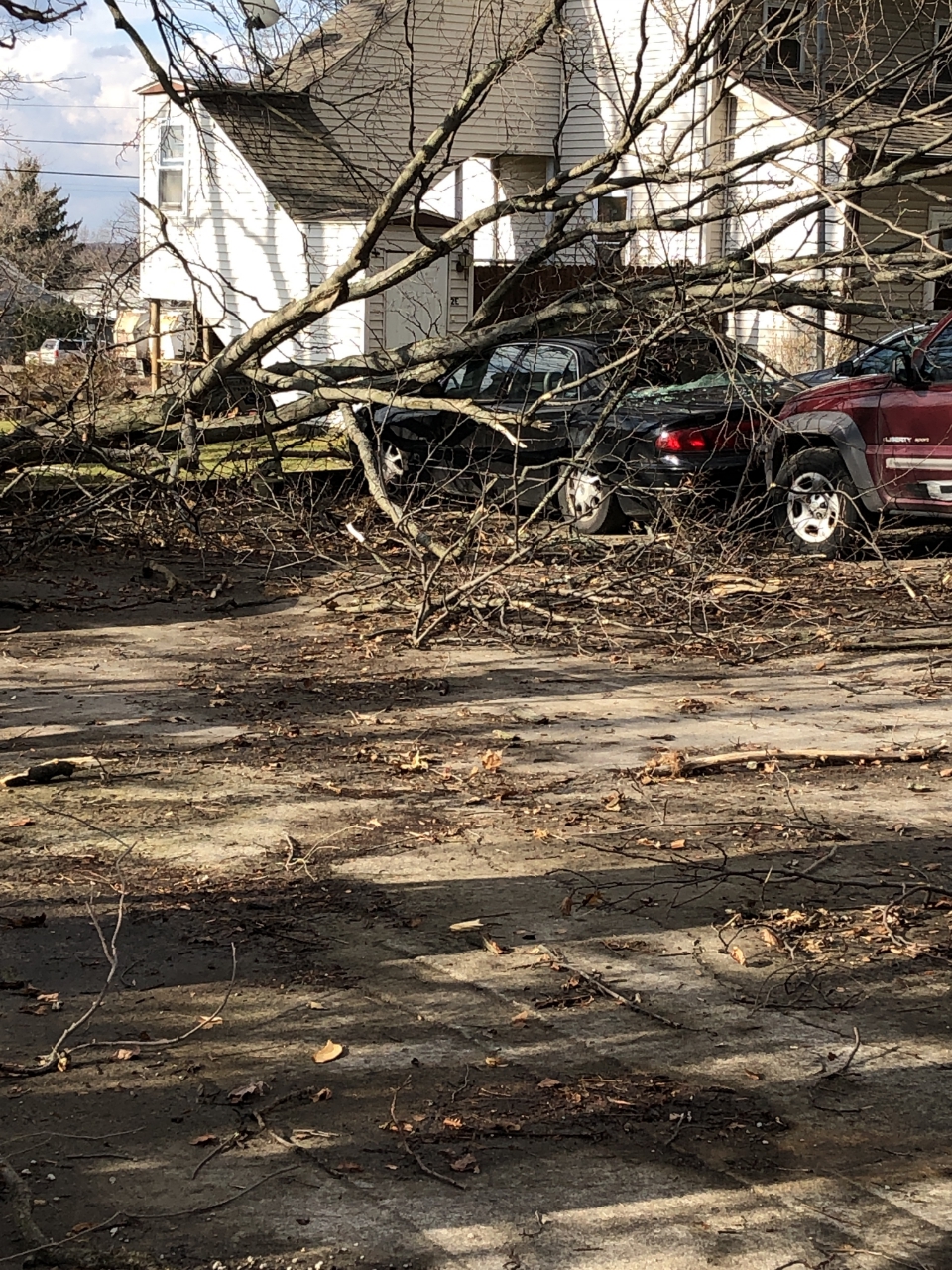 storm damage from Cortland tornado, house on cars