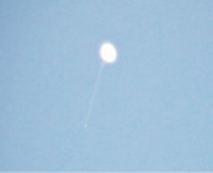 [ Weather Balloon as seen through a telescope.  The Balloon was approximately 50,000 feet in the air at this point.]