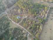 [ Aerial view showing damage to trees and houses. ]