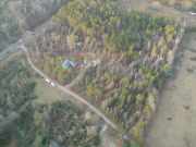 [ Aerial view showing damage to trees and houses. ]