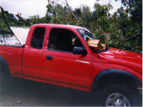 [ Damage to truck caused by tornado spawned by Ivan ]