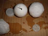 [ Hailstone compared to golfball and quarter. ]