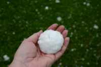 [ Hand holding large hailstone. ]