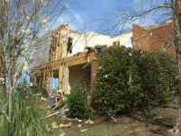 [ rear of severely damaged house ]