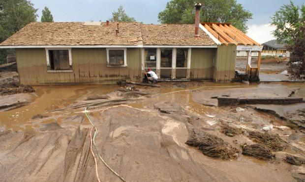 A wall of flood water and debris hit this home.