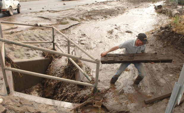 Clearing debris out of a drainage that was clogged during the flooding.