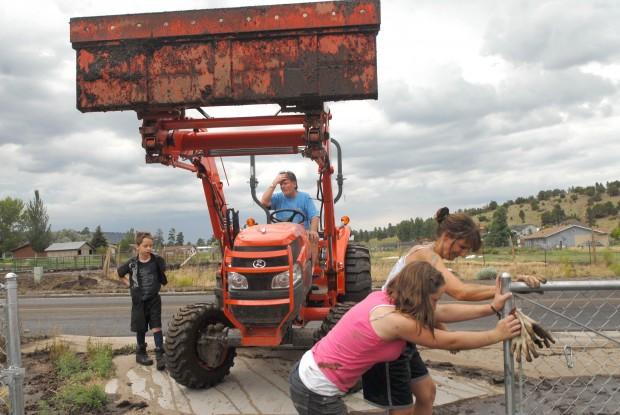 Clearing mud and debris leftover by flooding.