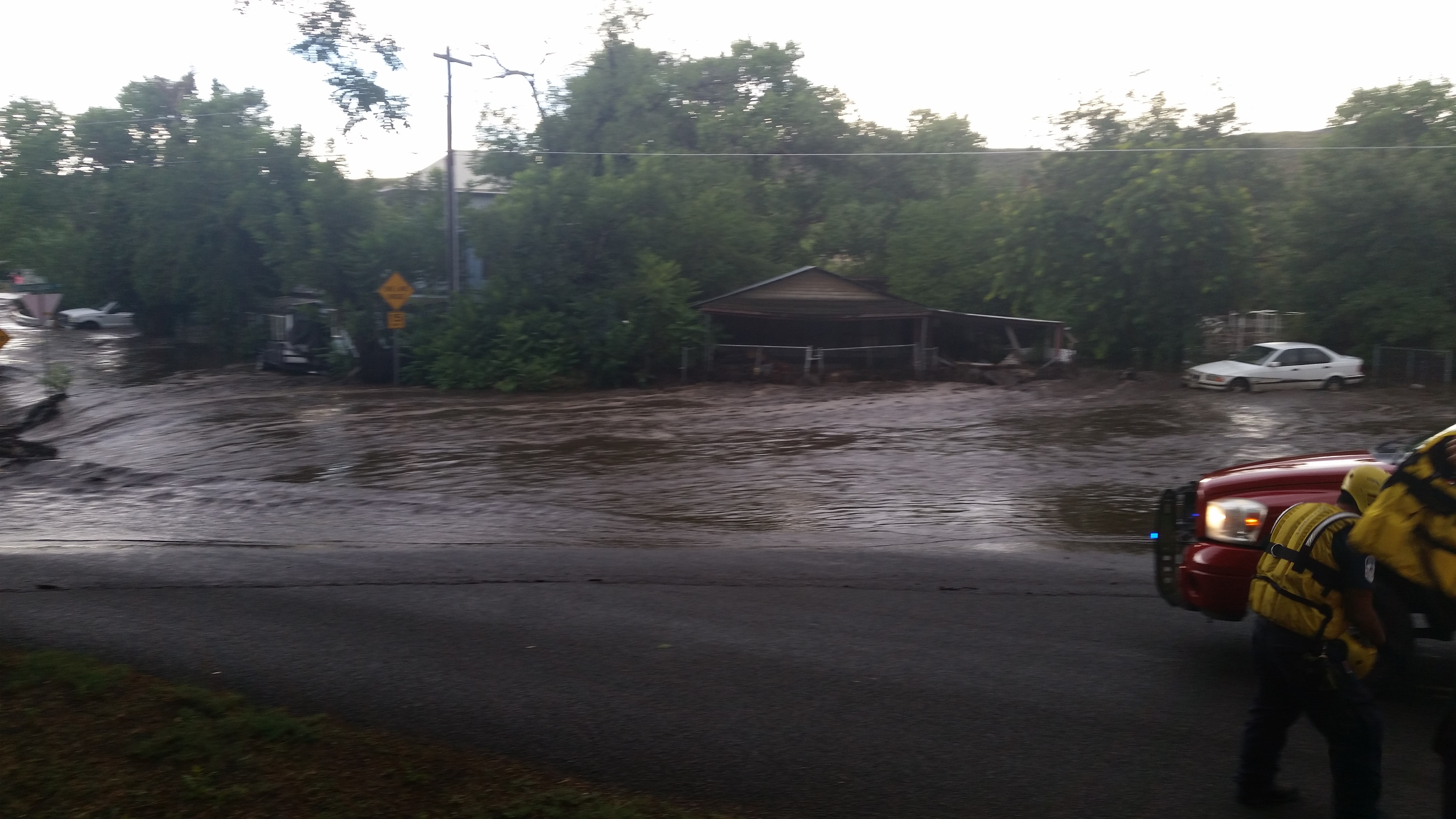Flooded roadway due to water overflowing the banks of Big Bug Creek in Mayer, AZ.