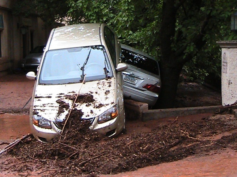 Mud, debris, and cars by Oak Creek Brewers (building on the left)