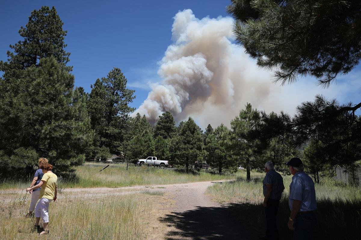 Plume of smoke generated by the Museum Fire with people standing in the foreground watching it.