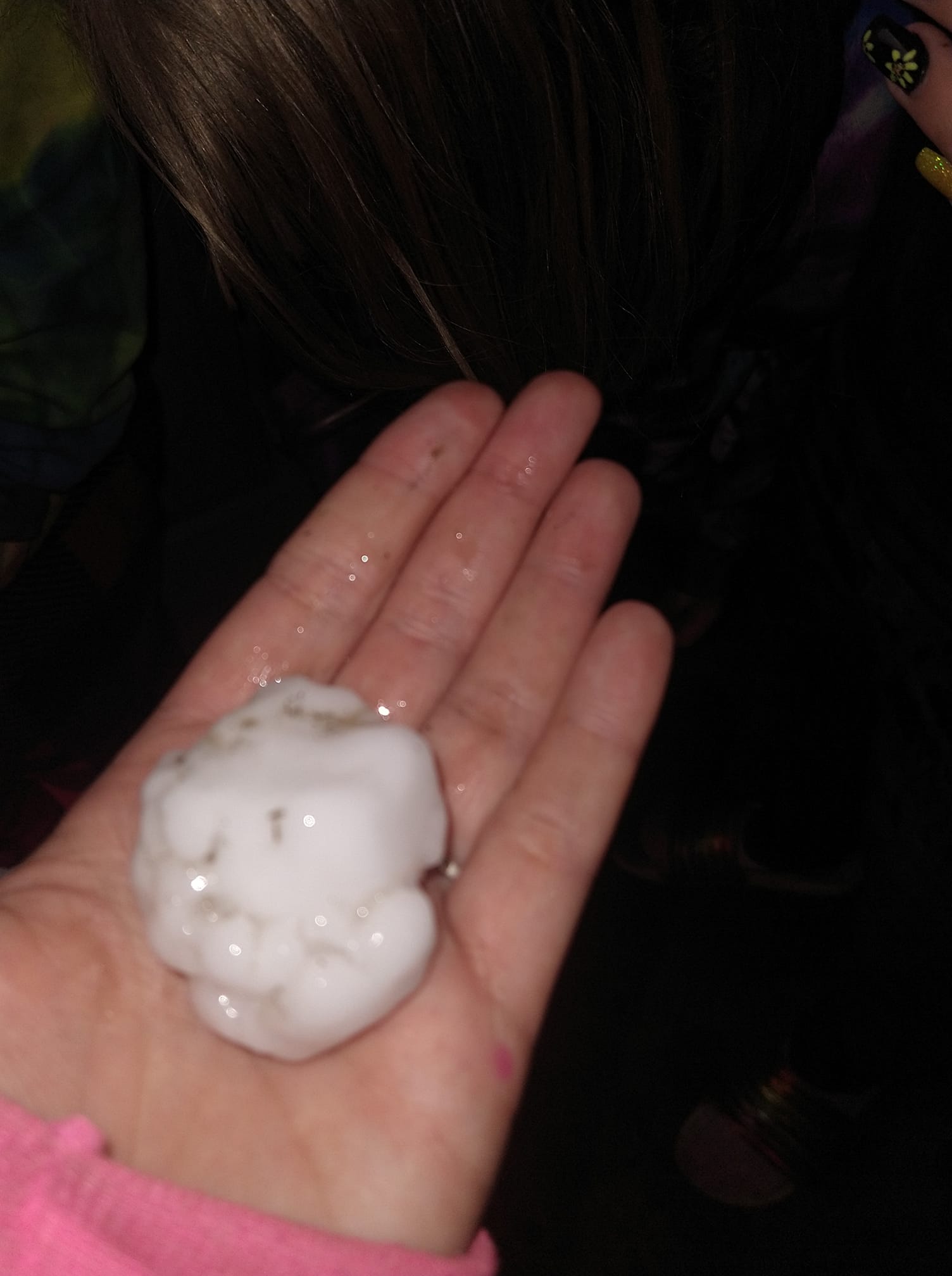 Hand holding golf ball sized, rough hail stone, 5 miles east of Parkston SD