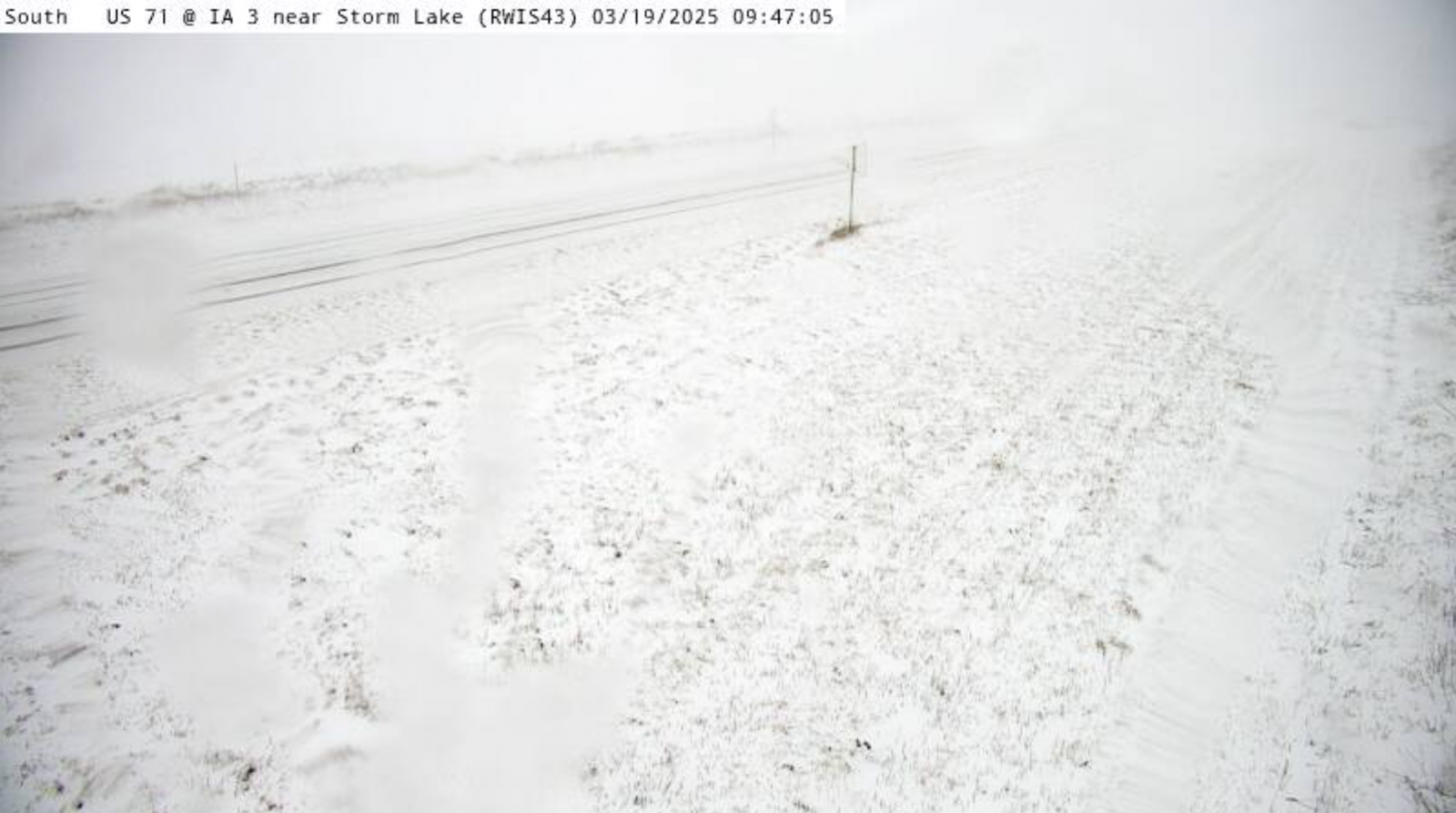 DOT webcam shows snow covered ground and near whiteout conditions near Storm Lake, IA