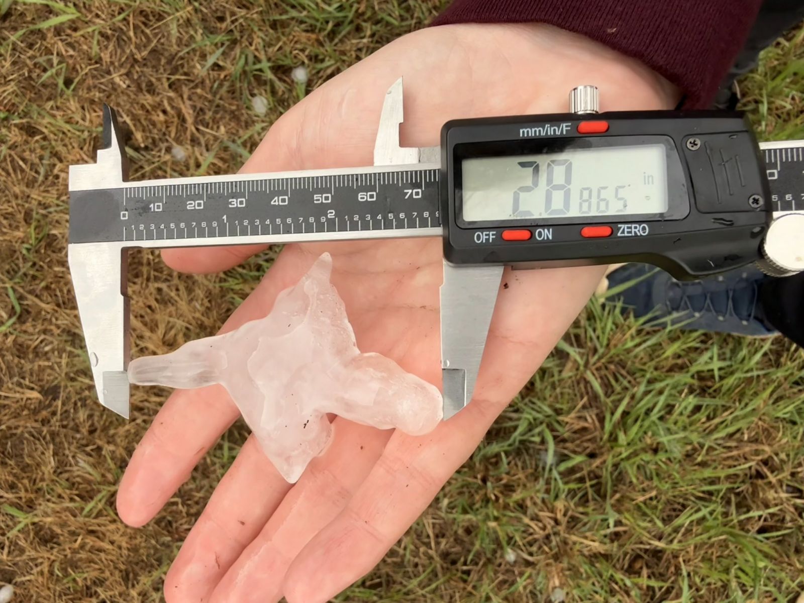 Photo of large and irregularly shaped hail measured at 2.8 inches at its widest point.