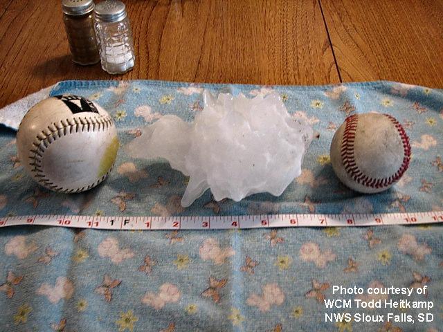 Hailstone measuring 6 and 7/8 inches across, compared to softball and baseball.