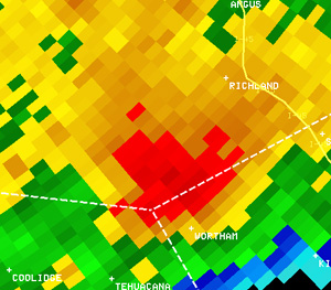 Reflectivity image (left) and velocity image (right) of the tornadic storm southwest of Richland, near the Freestone County line, at 7:35 am. In the velocity image, red indicates motion away from the radar in Fort Worth, and green indicates motion toward the radar.